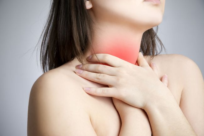 Sore throat of a women. Touching the neck.