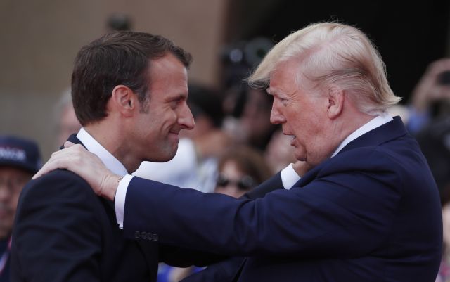 epa07630149 US President Donald Trump (R)   welcomes French President Emmanuel Macron (L) during the French - USA Commemoration marking the 75th anniversary of the Allied landings on D-Day at the Normandy American Cemetery and Memorial in Colleville-sur-Mer, France, 06 June 2019. World leaders are attending memorial events on 06 June in Normandy, France to mark the 75th anniversary of the D-Day landings, which marked the beginning of the end of World War II in Europe.  EPA/IAN LANGSDON / POOL