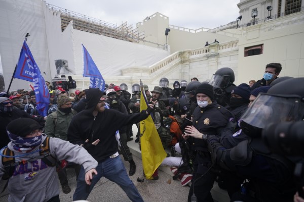 Trump supporters try to break through a police barrier, Wednesday, Jan. 6, 2021, at the Capitol in Washington. As Congress prepares to affirm President-elect Joe Biden's victory, thousands of people have gathered to show their support for President Donald Trump and his claims of election fraud. (AP Photo/Julio Cortez)