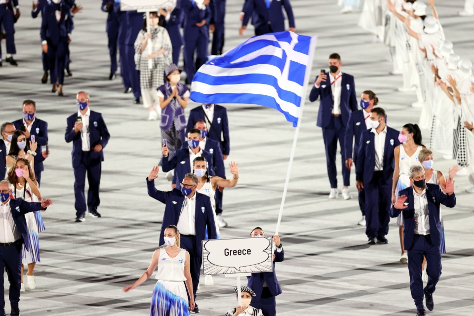 epa09359566 

Flag Bearers of Greece Anna Korakaki (L) and Eleftherios Petrounias enter the stadium during the Opening Ceremony of the Tokyo 2020 Olympic Games at the Olympic Stadium in Tokyo, Japan, 23 July 2021.  EPA/RITCHIE B. TONGO