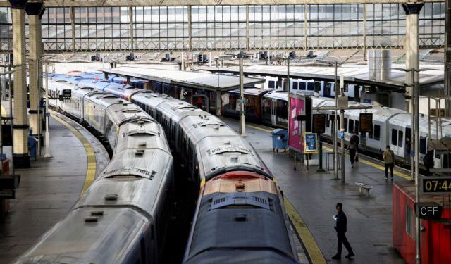 FILE PHOTO: A view of trains on the platform at Waterloo Station as a station worker stands nearby, on the first day of national rail strike in London, Britain, June 21, 2022. REUTERS/Henry Nicholls//File Photo