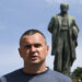 Ukrainian filmmaker and former Russian prisoner Oleg Sentsov, center, talks to reporters during an outdoor press conference in front of a monument to national poet Taras Shevchenko in Kyiv, Ukraine, Friday, June 19, 2020. Sentsov and other former Russian prisoners demanded the Ukrainian authorities to stop political repressions. (AP Photo/Efrem Lukatsky)