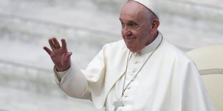 Pope Francis waves as he arrives for an audience with members of St. Pietro and Paolo association, in the Paul VI Hall at the Vatican, Saturday, Jan. 8, 2022. (AP Photo/Alessandra Tarantino)