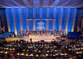 FILE- This Tuesday, Nov. 5, 2013, file photo shows a general view of the UNESCO prior to the opening of General Conference in Paris, France. American influence in culture, science and education around the world will take a high-profile blow on Friday as the US is stripped of its vote at the world's premier cultural agency, UNESCO. The U.S. loses its vote at the Paris-based U.N. Educational, Scientific and Cultural Organization following Washington's decision in 2011 to cut all funding to the U.N. agency over the vote giving Palestine member-state status. (AP Photo/Benjamin Girette, file)