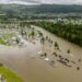 This aerial view taken on August 9, 2023 shows the camping site in Dokka flooded after the Dokka River overflowed its banks. Heavy rains caused flooding and landslides in Sweden and Norway on August 8 while strong winds caused a Danish wildfire to spread out of control, authorities said, with more heavy rain forecast. A storm dubbed "Hans" swept in over the Nordic countries over the weekend, leaving a path of destruction. Norway police reported several landslides in the southeast, with media reporting that over 100 people had been evacuated as a result. (Photo by Stian Lysberg Solum / NTB / AFP) / Norway OUT