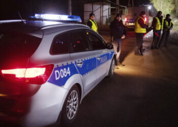 Police officers gather outside a grain depot in Przewodow, eastern Poland, on Tuesday Nov. 15, 2022 where the Polish Foreign Ministry said that a Russian-made missile fell and killed two people. The ministry said Foreign Minister Zbigniew Rau summoned the Russian ambassador and "demanded immediate detailed explanations." (AP Photo)