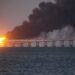 FILE - Flame and smoke rise fron Crimean Bridge connecting Russian mainland and Crimean peninsula over the Kerch Strait, in Kerch, Crimea, Saturday, Oct. 8, 2022. The Crimean Peninsula's balmy beaches have been vacation spots for Russian czars and has hosted history-shaking meetings of world leaders. And it has been the site of ethnic persecutions, forced deportations and political repression. Now, as Russia’s war in Ukraine enters its 18th month, the Black Sea peninsula is again both a playground and a battleground. (AP Photo, File)