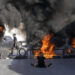 Tires set fire by Palestinians burn at the site where two Palestinians were shot and killed by the Israeli army in the Jalazone refugee camp near the city of Ramallah, West Bank, Monday, Oct. 3, 2022. Palestinian officials say the Israeli military has killed two Palestinians in the occupied West Bank. The Israeli military says it was on an arrest raid early Monday and alleges the two suspects tried to ram their car into soldiers, a claim that could not be independently verified. (AP Photo/Majdi Mohammed)