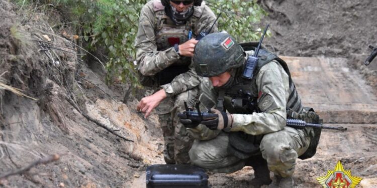 A fighter from Russian Wagner mercenary group and a Belarusian service member take part in a joint training at the Brest military range outside Brest, Belarus, in this still image released July 20, 2023. Belarusian Defence Ministry/Handout via REUTERS ATTENTION EDITORS - THIS IMAGE WAS PROVIDED BY A THIRD PARTY. NO RESALES. NO ARCHIVES. MANDATORY CREDIT.