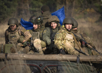 A soldier of the Ukraine's National Guard 1st brigade Bureviy (Hurricane) ride an APC during combat training at a military training ground in the north of Ukraine Friday, Nov. 3, 2023. (AP Photo/Efrem Lukatsky)